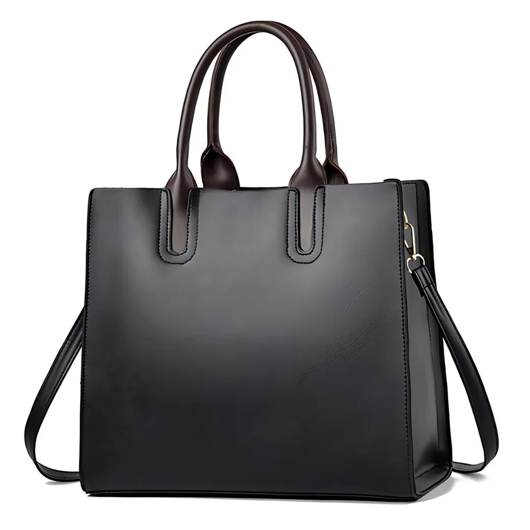 Black leather tote bag with dual brown handles and detachable shoulder strap