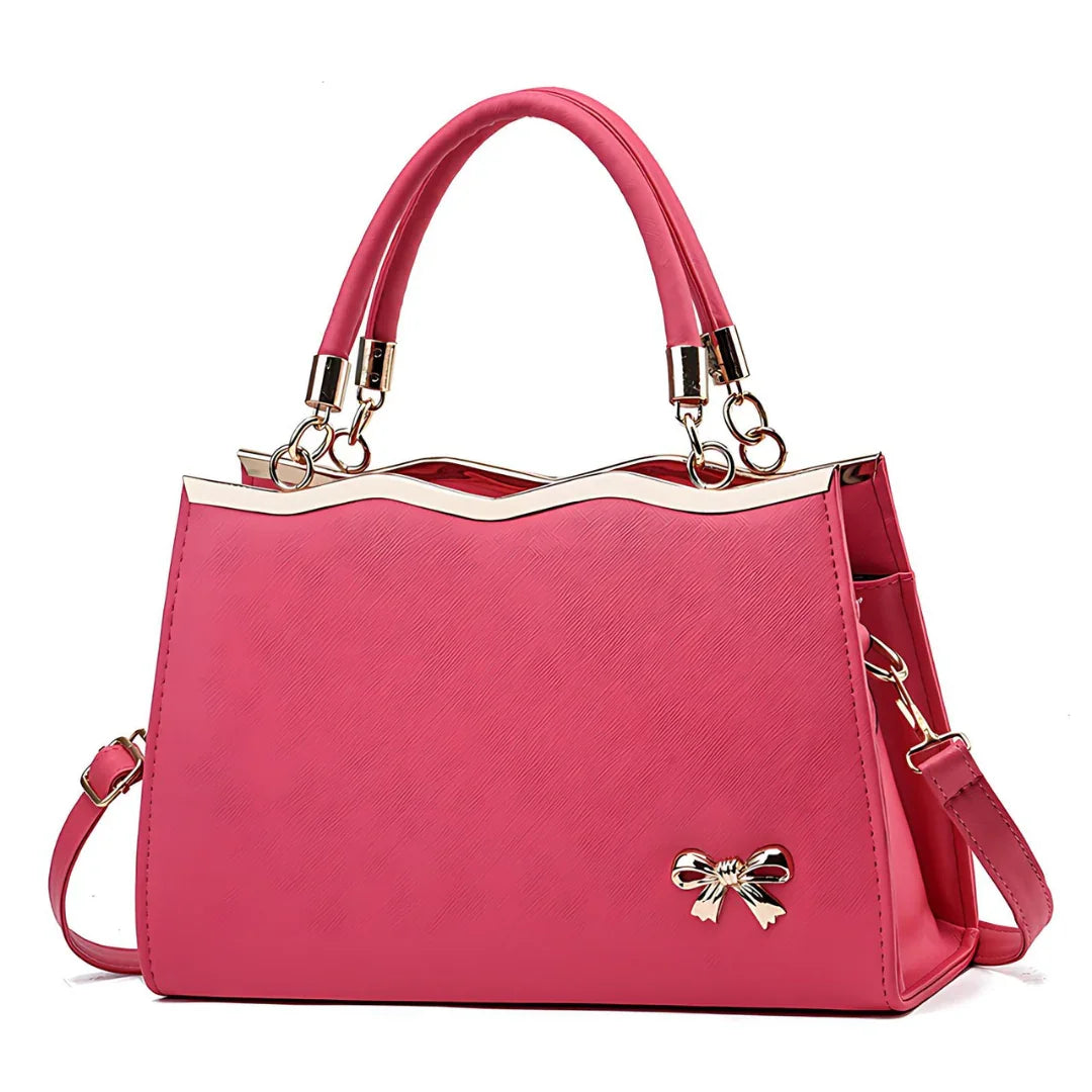 Elegant pink handbag with gold metal trim, top handles, and bow accent, women's fashion purse