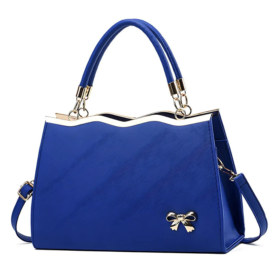 Elegant blue handbag with gold bow accent and wave edge design, detachable strap