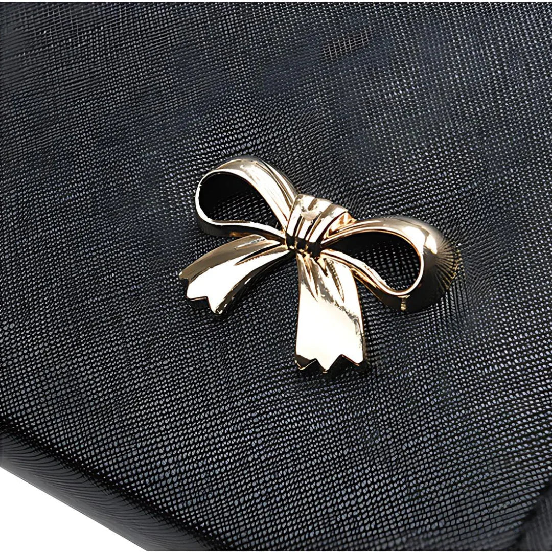Black textured clutch with gold bow accent