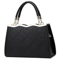 Elegant black handbag with gold trim and dual handles on a white background