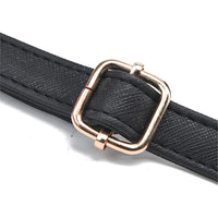 Black textured belt with gold square buckle on white background