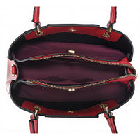 Interior view of red handbag with multiple zippered compartments and gold hardware