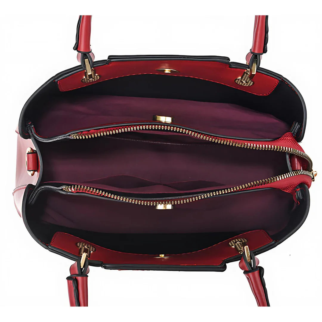 Interior view of red handbag with multiple zippered compartments and gold hardware