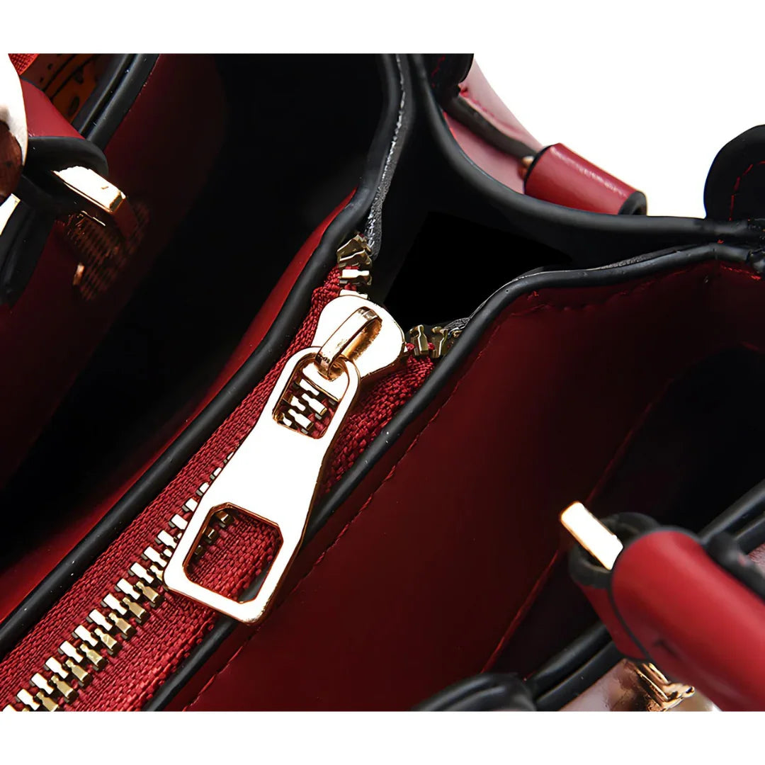 Close-up of red handbag interior with gold zipper and black trim