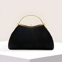 Elegant black pleated handbag with gold handle and clasp on a white display pedestal