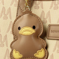 Brown duck keychain on beige patterned bag with Lemon emblem branding
