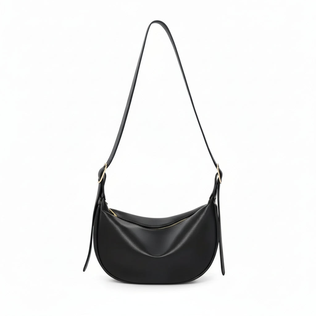 Black leather crescent shoulder bag with zipper, minimalist design on white background