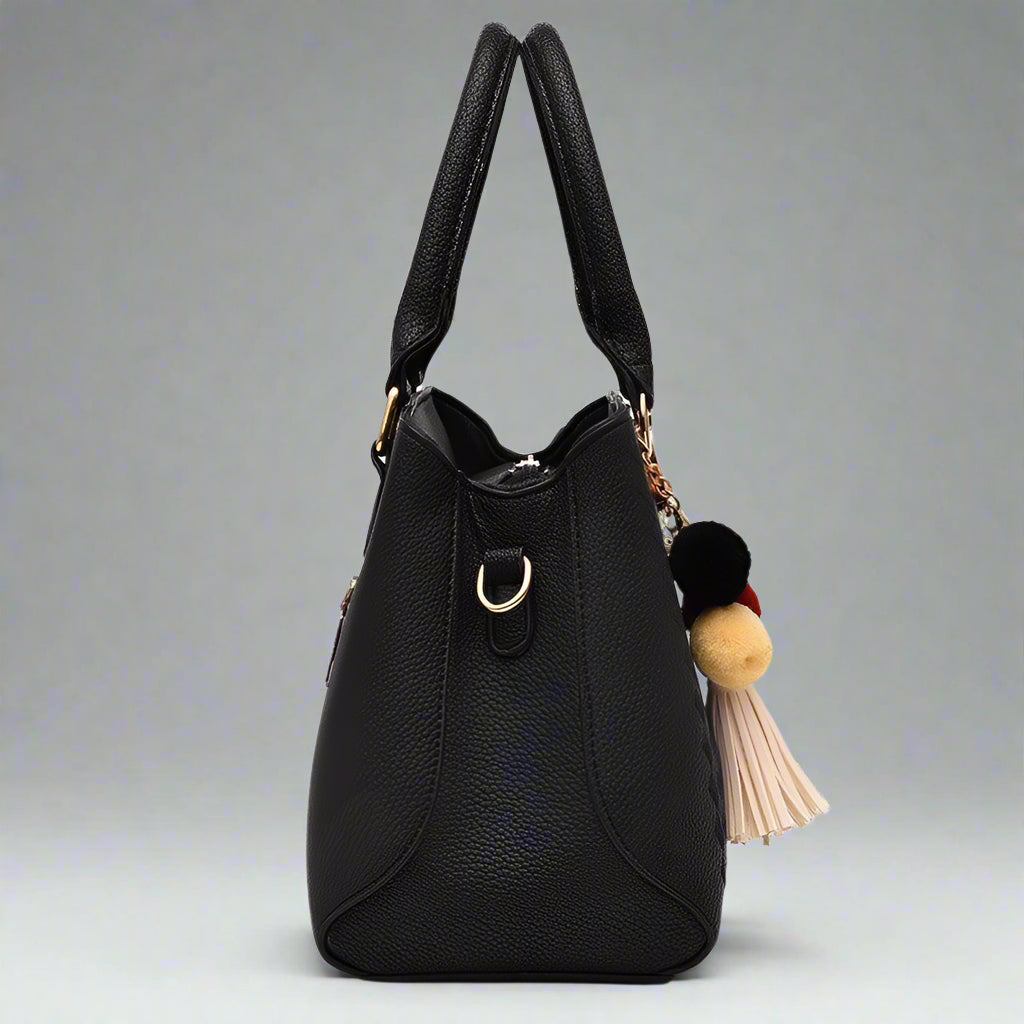 Women's luxury black leather crossbody handbag with pompom and tassel charm