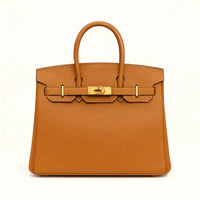 Women's genuine leather tote bag in tan with gold hardware on a white background