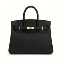 Black genuine leather tote bag with gold hardware on white background