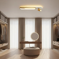 Ceiling light fixture in a room with clothing on a rack and a window.