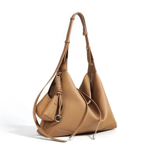 Brown leather bucket bag with long adjustable strap and decorative knot detail