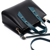 Black handbag with teal straps and gold hardware, modern leather purse on white background