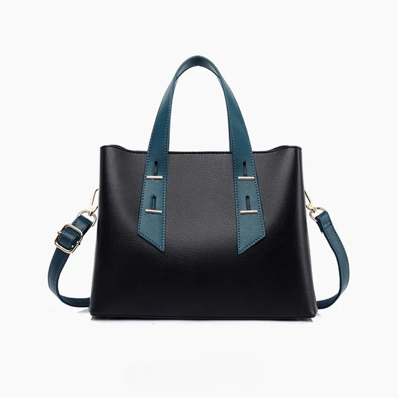 Black leather handbag with blue handles and shoulder strap on white background