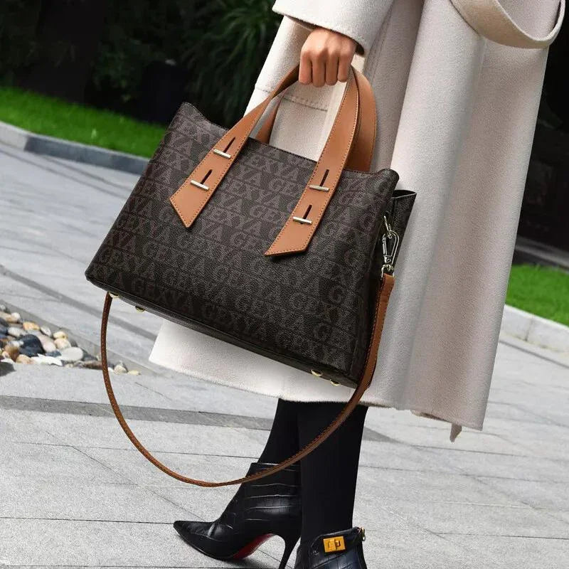 Woman in beige coat holding designer brown tote bag with tan leather handles outdoors