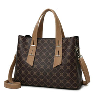 Brown tote handbag with geometric pattern, tan leather handles, and detachable strap