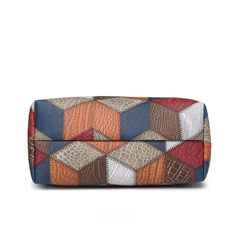Patchwork leather handbag with geometric cube pattern in blue, orange, brown, and red tones