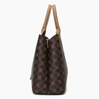 Side view of brown patterned tote bag with beige leather handles on white background