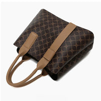 Brown patterned tote bag with leather handles on white background