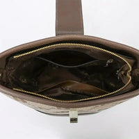 Brown leather handbag with gold zipper and spacious interior compartments