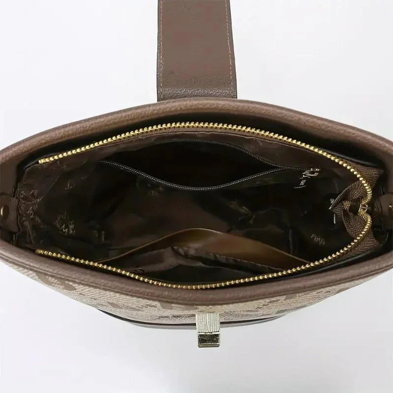 Brown leather handbag with gold zipper and spacious interior compartments