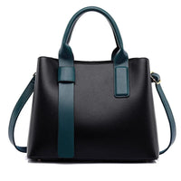 Black leather handbag with teal handles and strap, modern women's fashion purse