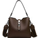 Brown leather handbag with metal clasp and adjustable strap on white background