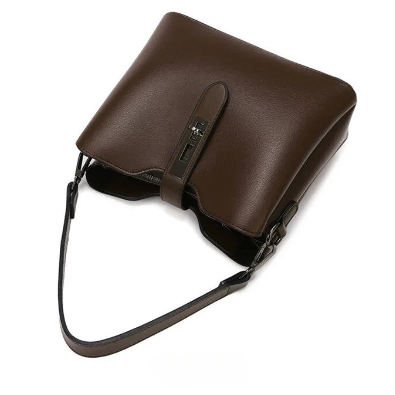 Brown leather shoulder bag with turn-lock closure and adjustable strap