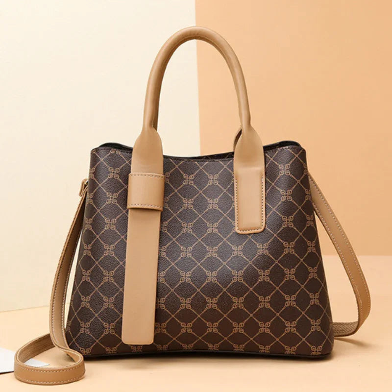 Brown leather handbag with geometric pattern and tan straps on neutral background