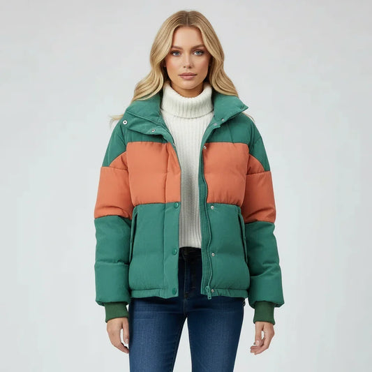 Woman wearing a green and orange puffer jacket on a white background